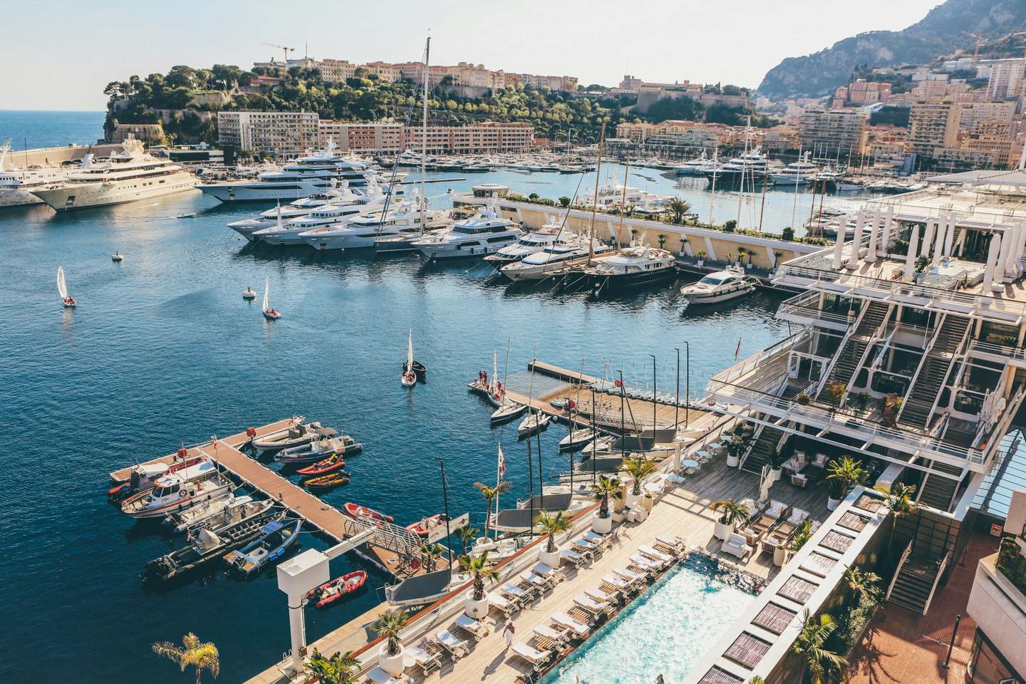 Aerial view of a Riviera marina with yachts and tenders along the pontoons